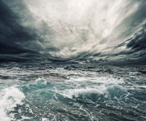 Dramatic stormy dark cloudy sky over sea natural photo background